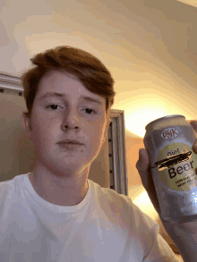 a young man holds a can of diet beer