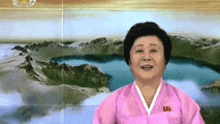 a woman in a pink kimono is smiling in front of a lake and mountains