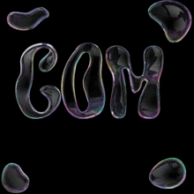 a black background with soap bubbles that spell out the word com