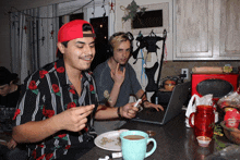 a man wearing a red hat is smoking a cigarette