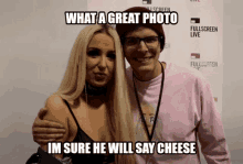 a man and a woman pose for a picture with a caption that says what a great photo im sure he will say cheese