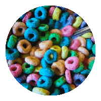 a pile of colorful cereal rings in a circle on a white background