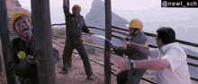 a group of men wearing hard hats are standing in front of a fence with the hashtag @newt_sch above them