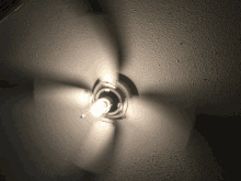 a ceiling fan with a light bulb in the middle of it