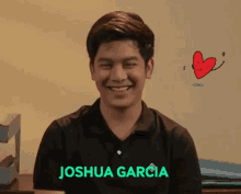 a young man in a black shirt with the name joshua garcia on it