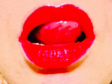 a close up of a person 's mouth with red lips and a tongue sticking out