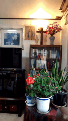 a living room with a picture of a man on the wall and a cross