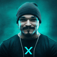 a man wearing a beanie and a black shirt with the letter x on the front