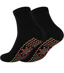 a pair of black socks with green and red polka dots on the bottom