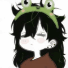 a girl wearing a frog headband on her head .