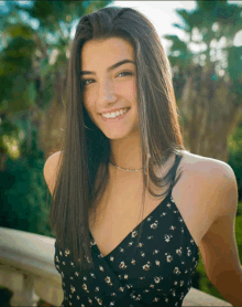 a girl with long hair and freckles is smiling for the camera