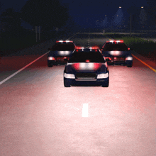 a row of police cars are driving down a road at night