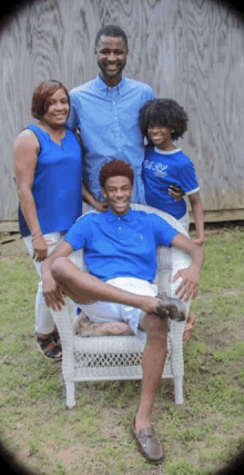 a family posing for a picture with a boy wearing a blue shirt that says ' ralph lauren '