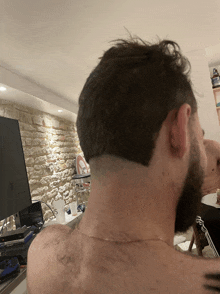 the back of a man 's head with a shaved line