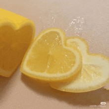 a heart shaped lemon sliced in half on a cutting board