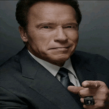 arnold schwarzenegger is wearing a ring on his left hand