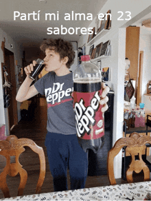 a boy drinking a glass of dr pepper