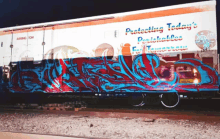 a train car with graffiti on it that says protecting today 's precious lives