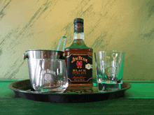 a bottle of jim beam next to two shot glasses