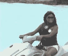 a woman is riding a jet ski in a swimming pool .