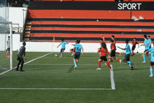 a group of soccer players on a field with a sign that says sport in the background