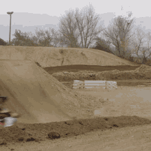 a blurred image of a person riding a dirt bike on a dirt track with a tv logo in the background