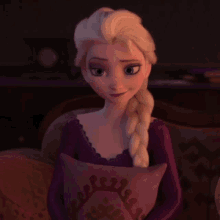 a close up of elsa from frozen sitting on a couch holding a pillow