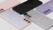 four different colored samsung phones are on a white surface