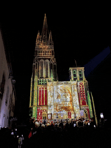 a crowd of people are gathered in front of a very tall building that has a clock tower on it