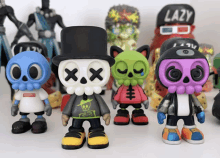 a group of toy figures with one wearing a hat that says lazy on it