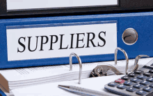 the word suppliers is on a blue binder