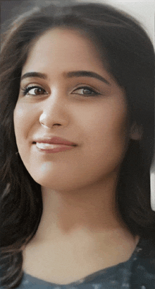 a close up of a woman 's face with a slight smile on her face