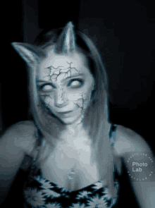 a woman with horns on her face has a photo lab watermark on her shoulder