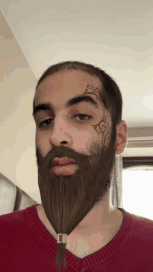 a man with a beard has a tattoo on his face