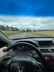 a honda car is driving down a road with a radio that says cruise