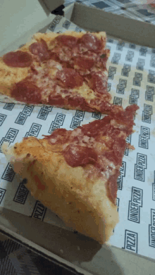 a slice of pepperoni pizza in a box that says ' pizza ' on it