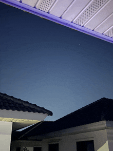 a house with a blue roof and a white roof