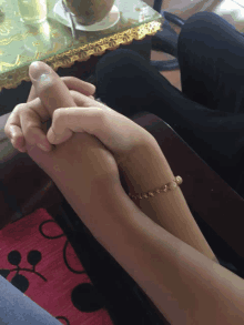 a man and a woman holding hands while sitting on a couch