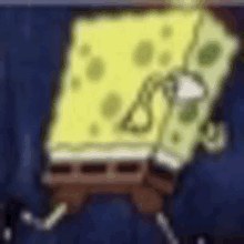 a close up of a spongebob squarepants cartoon character sitting on a table .