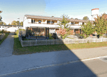 a trampoline sits in front of a fenced in yard