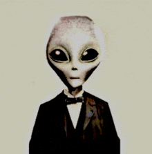 an alien in a tuxedo and bow tie