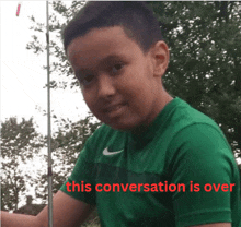 a boy in a green nike shirt is holding a fishing rod and the caption says this conversation is over