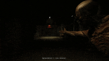 a screenshot of a video game in a dark hallway with a red exit sign