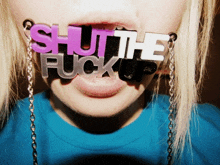 a woman wearing a necklace that says shut the fuck up on it