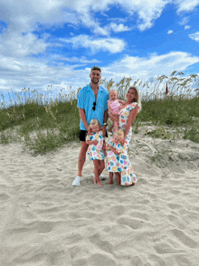 a family poses for a picture on a beach