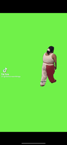 a woman is walking on a green screen in a tik tok video .