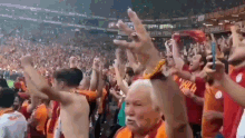 a crowd of people in a stadium with a sign on the wall that says ' istanbul ' on it