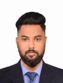 a man with a beard is wearing a blue shirt and tie