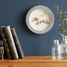 a shelf with books and a clock on it that says ' ocean ' on it