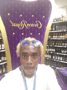 a man is sitting in a crown royal chair